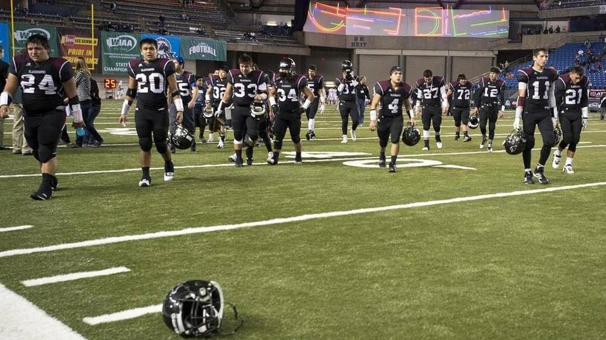 The Lummi football team walks off the field at the Tacoma Dome after falling 46-42 to Almira-Coulee-Hartline in the Class 1B State Championship game Dec. 4, 2015. Following that loss, the Blackhawks were is one of six teams chosen nationwide for Russell’s national integrated marketing campaign “Team On” in a series titled #SettleYourScore.