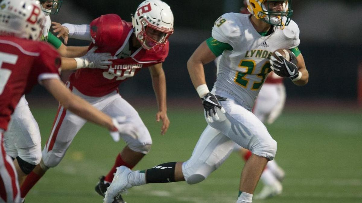 Lynden’s Trevin Melendez returns an interception for a touchdown against Bellingham on Friday at Civic Stadium in Bellingham.