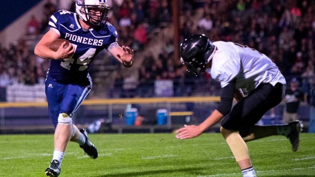 Nooksack Valley’s Colton Kautz, left, looks for running room against Meridian Sept. 30.
