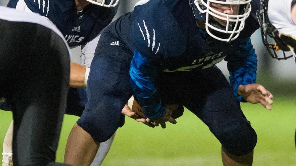 Lynden Christian's John-Mark Stromberg snaps the ball and prepares to block a defender during a game against Meridian on Friday, Sept. 25, at Lynden Christian High School in Lynden.