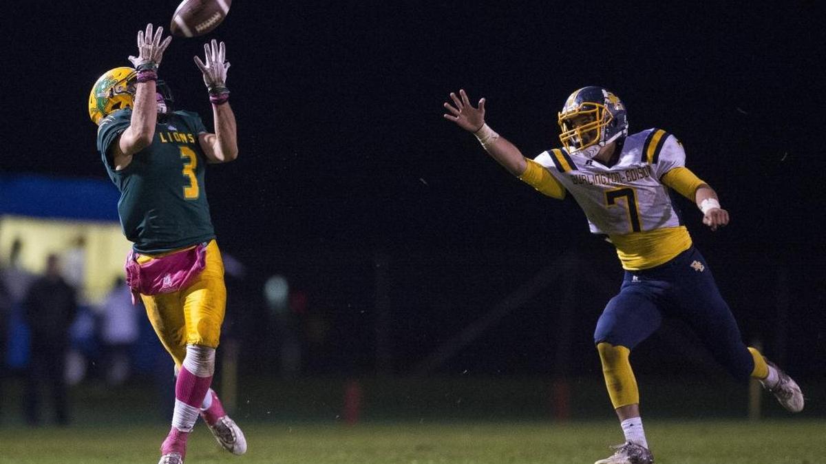 Lynden’s Rylan Severson, left, hauls in a pass against Burlington-Edison’s Brett Rawlins to score a touchdown Oct. 21 at Lynden High School.
