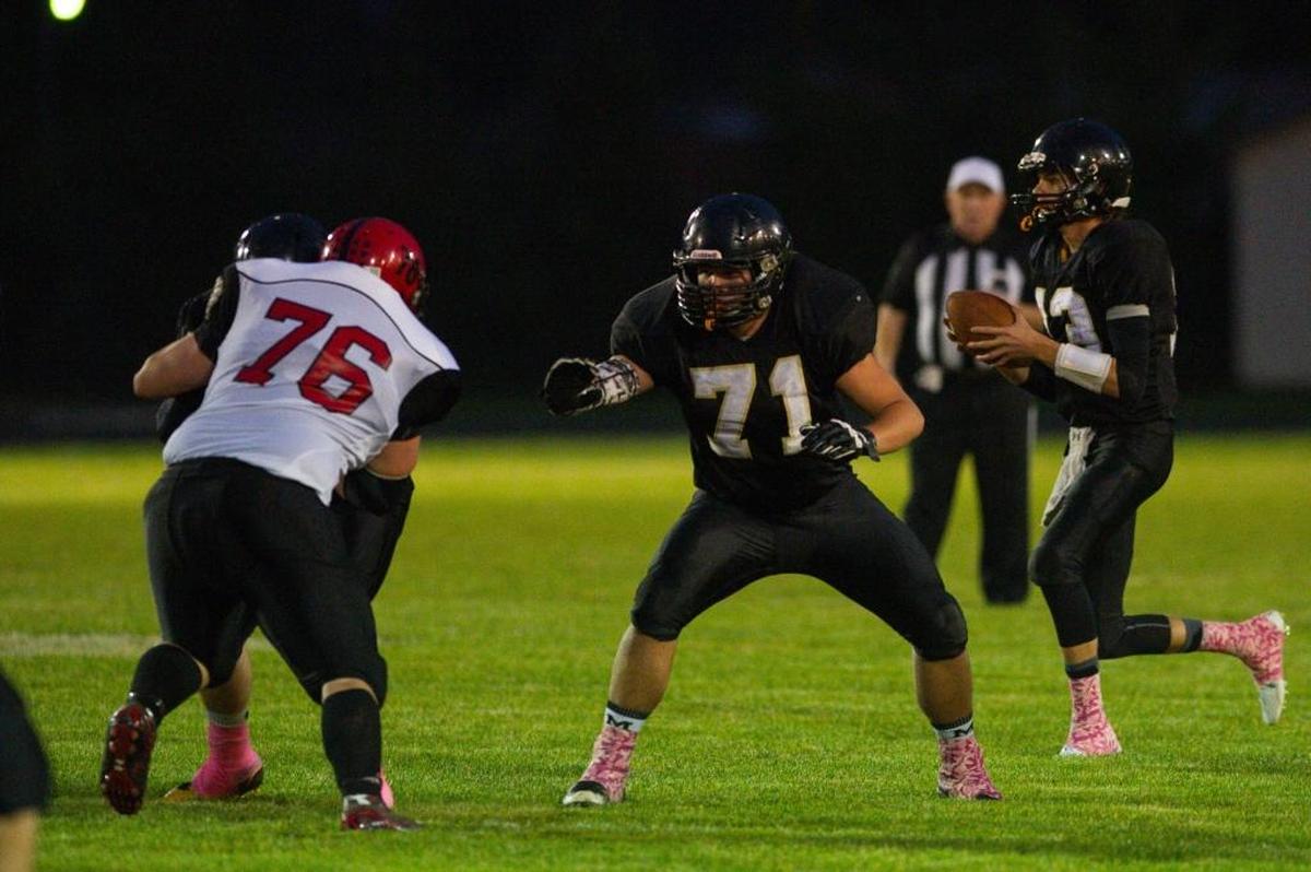 Meridian quarterback Simon Burkett, right, looks downfield during a game against Mount Baker on Oct. 2.