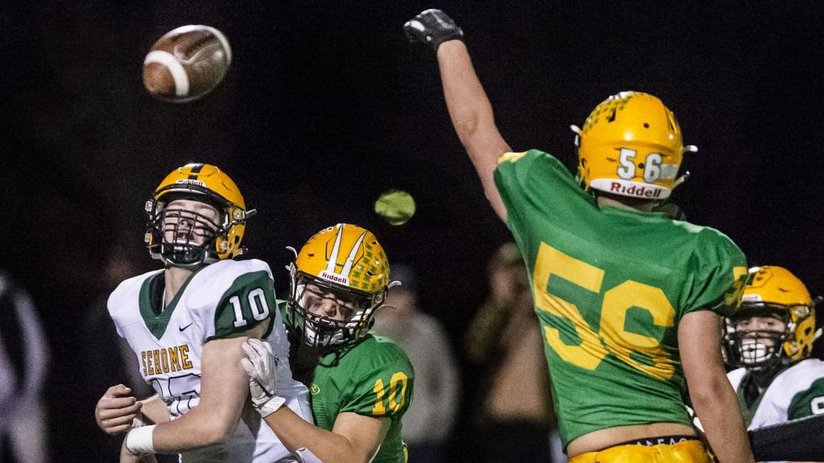 Lynden defensive lineman Case Zweegman (56), right, blocks a pass from Sehome quarterback Jacob Kaepernick (10) as he is being tackled by defensive back Cade Slayton (10) during the second quarter for a loss of 5 yards in their Division 2A playoff game in November 2019, at Civic Field in Bellingham.
