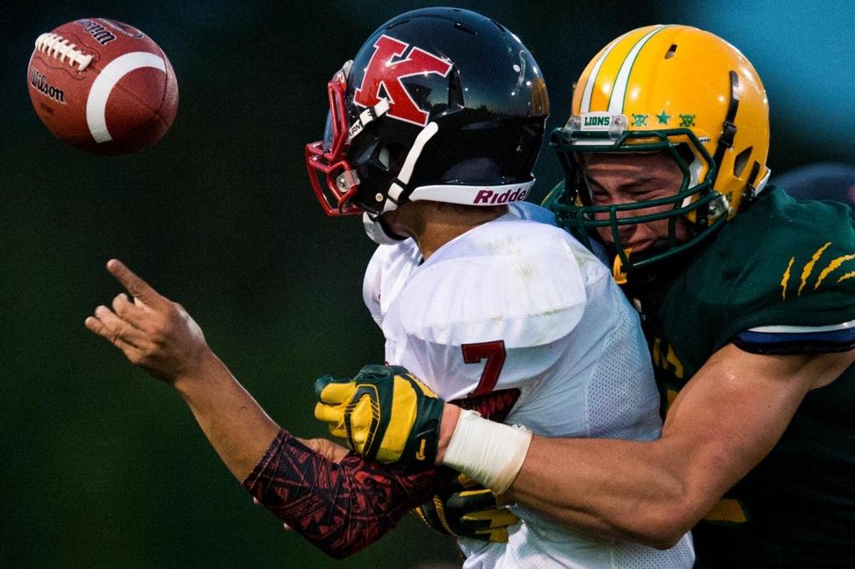 Lynden’s Bryce Sterk sacks and forces a fumble from Kings’ Koa Wilkins on Sept. 5, 2014 in Lynden, Wash. Sterk is transferring from the University of Washington to Montana State University.