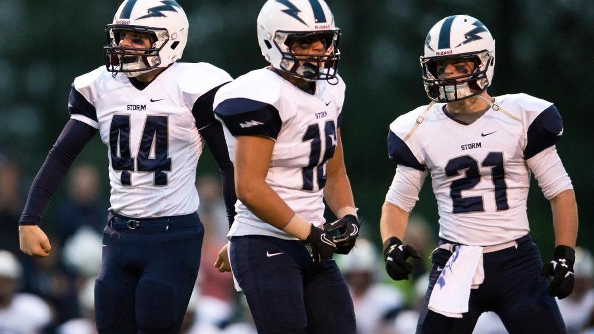 Squalicum's Jack Wendling, Creighton Kaui and Jake Burns celebrate a stop on defense on Friday, Sept. 18, at Lynden High School in Lynden.