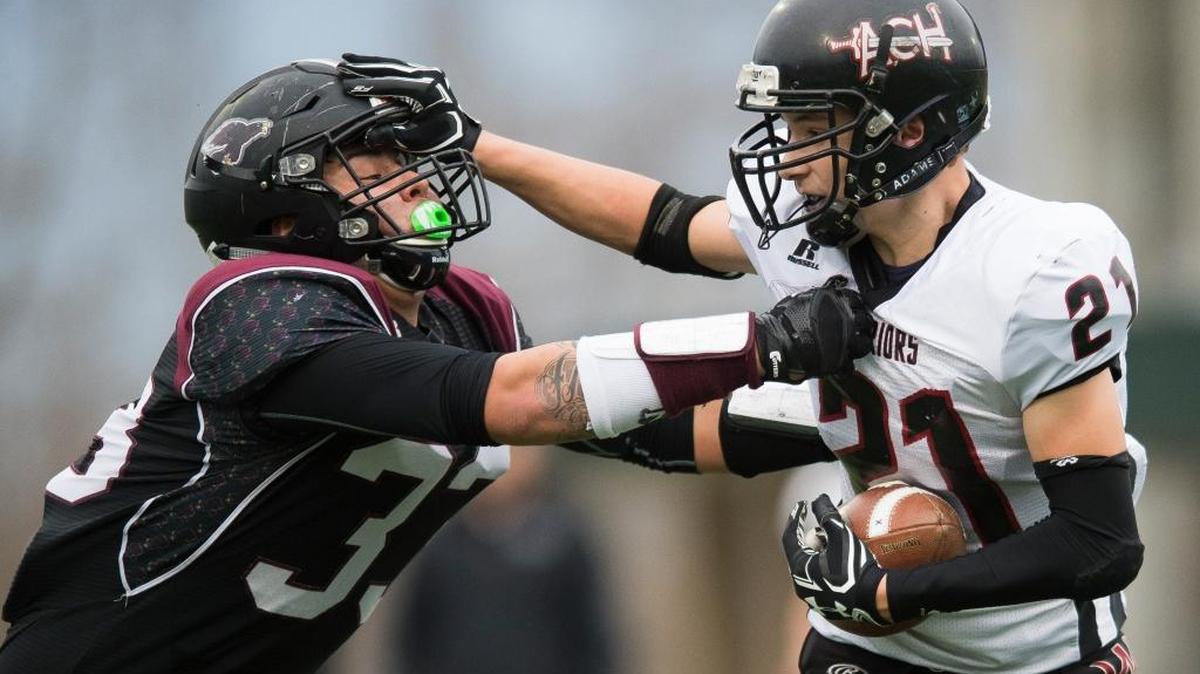 Almira-Coulee-Hartline’s Brayton Schafer, right, breaks a tackle by Lummi's James Williams on Saturday, Nov. 25, at Civic Stadium in Bellingham.