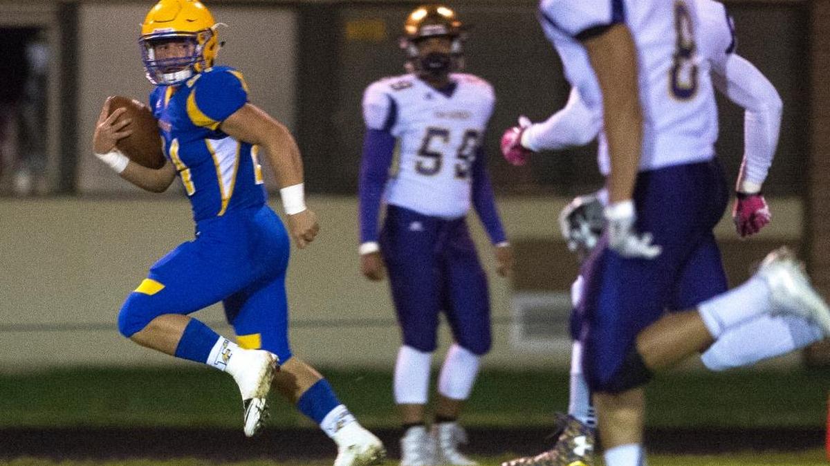 Ferndale’s Cole Semu looks back at Oak Harbor defenders as he runs 72 yards for a touchdown Friday, Oct. 14, at Ferndale High School.