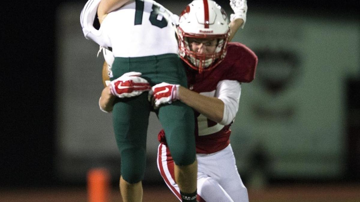 Bellingham’s Ethan Fields hits Charles Wright’s Alex Meadowcroft as he tries to catch a pass on Saturday, Sept. 26, at Civic Stadium.