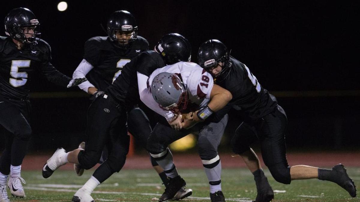Meridian defenders corral Hoquiam quarterback Payton Quintanilla in a Class 1A state football playoff game on Saturday, Nov. 11, in Bellingham.