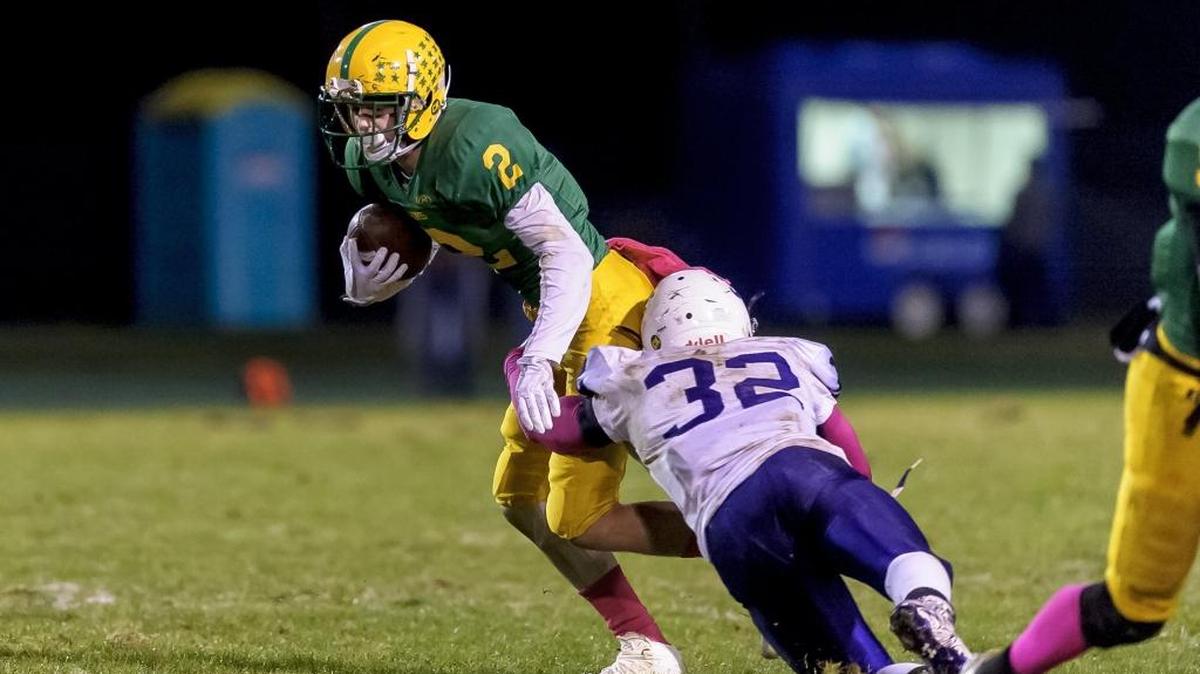 Lynden receiver Kobe Elsner tries to avoid Anacortes defender Payton Beaner in an Oct. 13 game. The Lions learned Saturday that they will be moving on to the Class 2A Bid-District Playoffs and will play at Sedro-Woolley Friday.