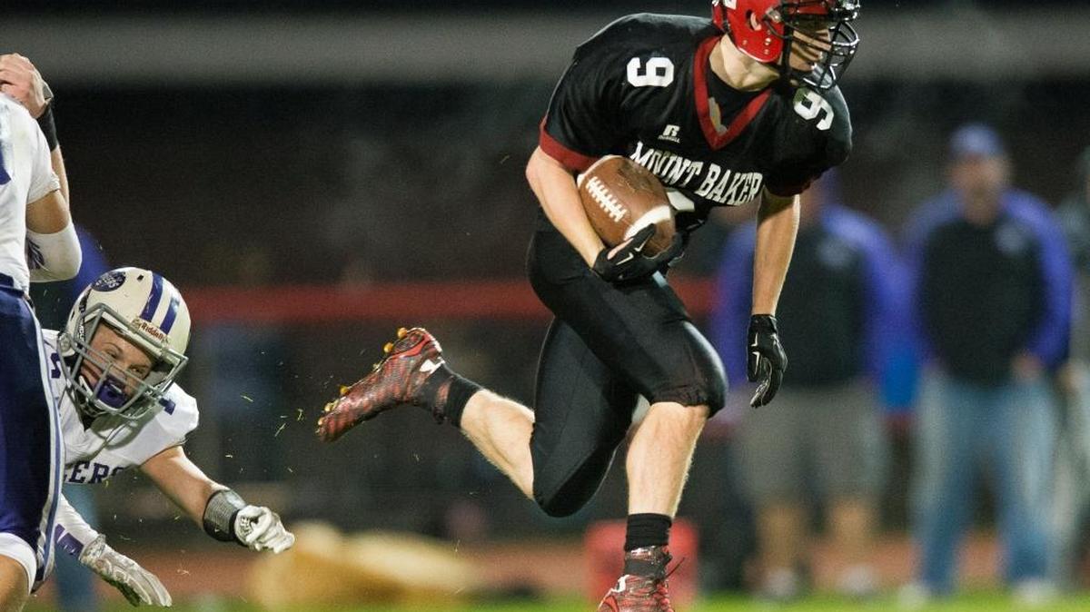 Mount Baker’s Carson Brandland, right, slips away from Nooksack Valley’s Austin O'Bryan during a 36-yard touchdown run on Friday.