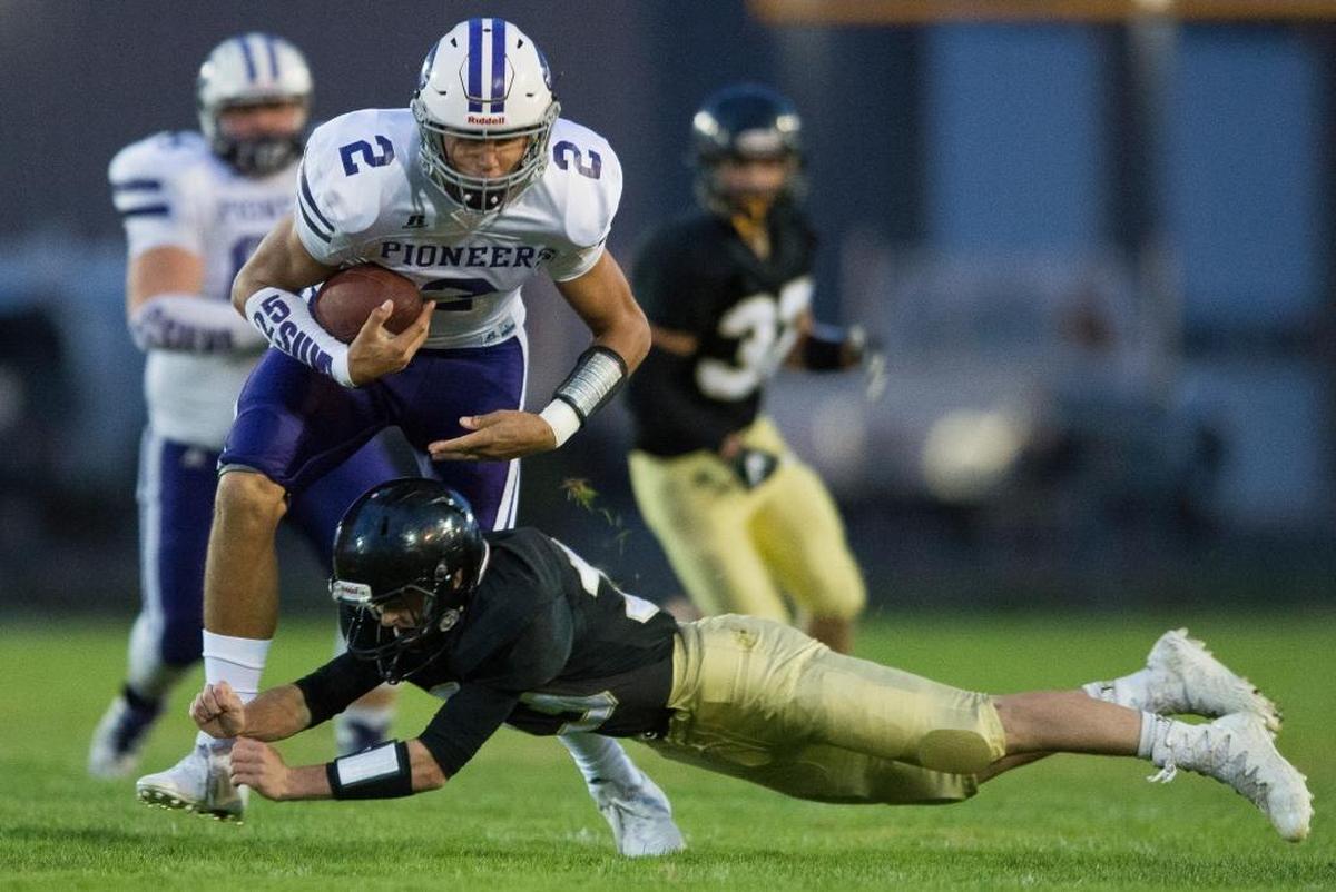 Meridian’s Dylan Hickok, bottom, tackles Nooksack Valley’s Casey Bauman Sept. 29 in Laurel.