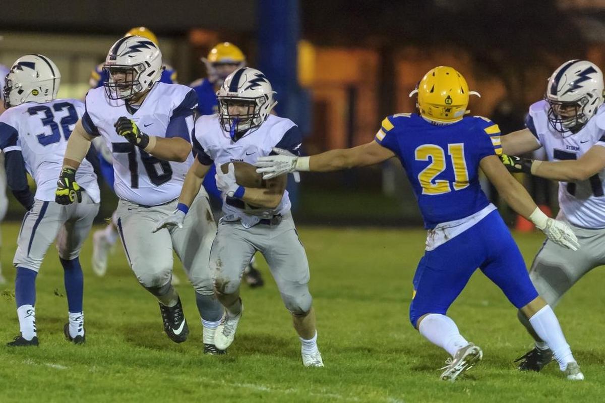 Squalicum running back Triston Smith tries to avoid Ferndale’s Cole Semu during an Oct. 20 game. Smith leads Whatcom County with 1,500 yards rushing this year.