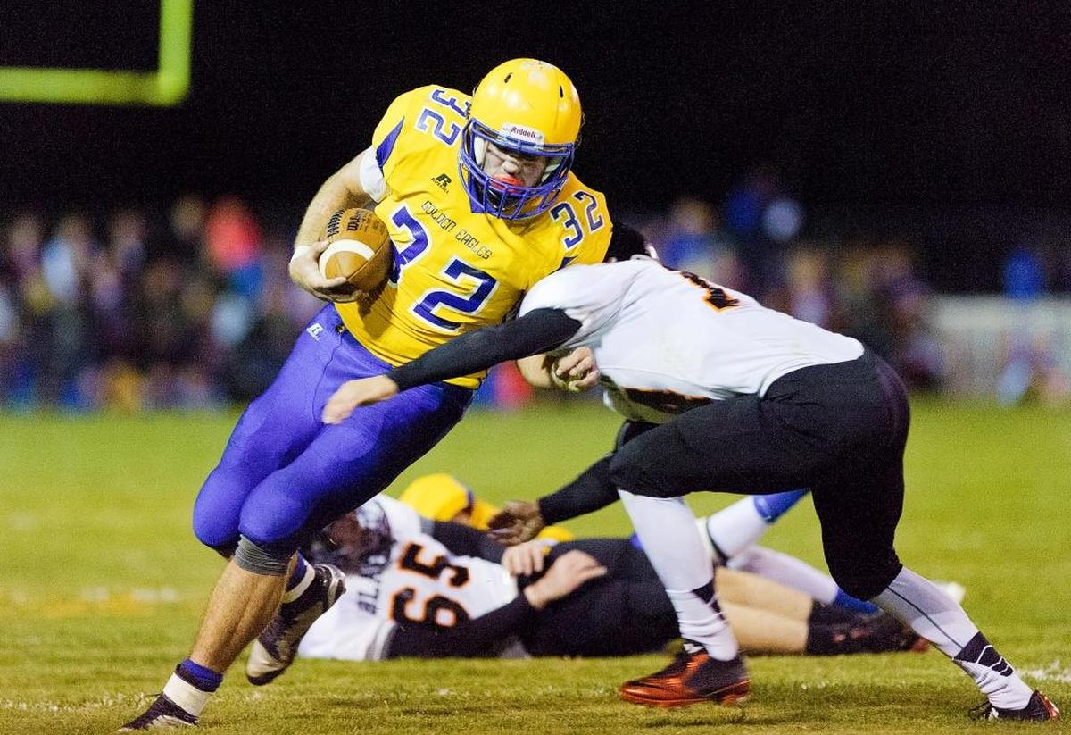 Blaine defensive back Alfonso Dermendziev (14), right, attempts to tackle Ferndale running back Austin Honeycutt (32) as he pushes past the line of scrimmage on Friday, Sept. 18.