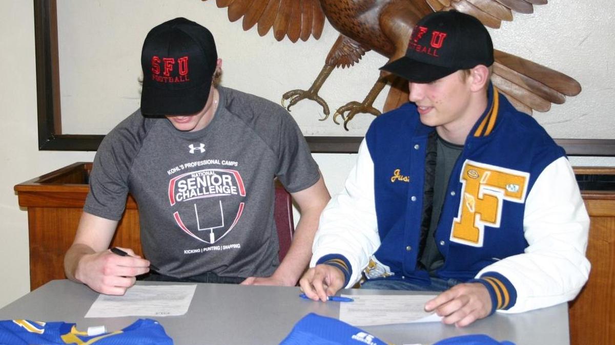 Patrick Hegarty, left, and Justice Powell sign their National Letters of Intent to play football for Simon Fraser March 15 at Ferndale High School.
