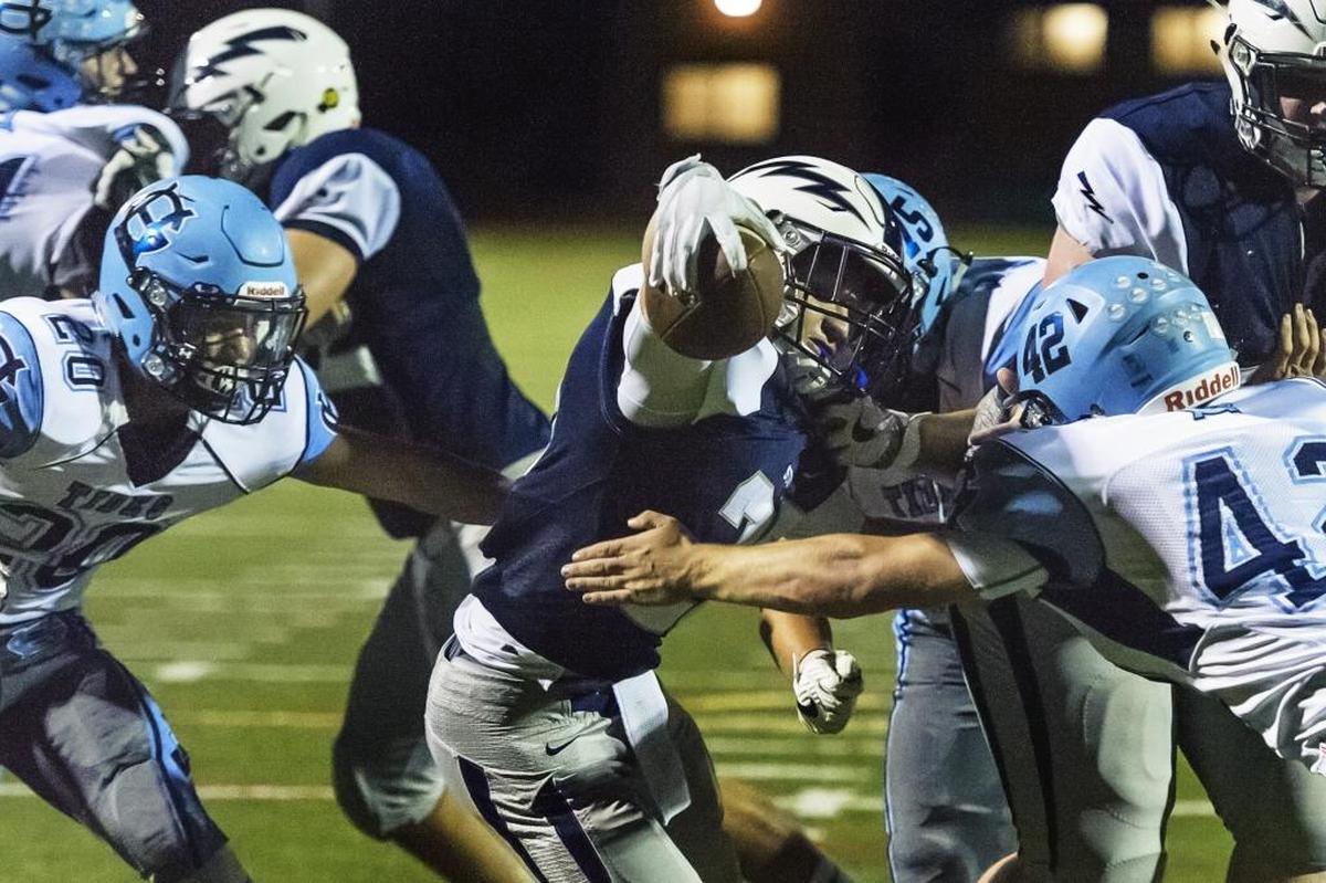 Squalicum’s Tristen Smith reaches for a touchdown between Gig Harbor's Jake Bruess, right, and CP Loughren Sept. 1. Smith rushed for 1,647 yards this year to lead Whatcom County.