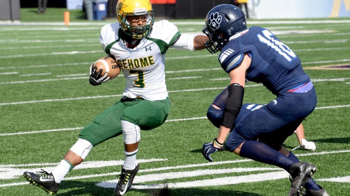 
Sehome running back Dalton Nestlebush tries to get around a Cascade Christian defender during a non-league game at the Emerald City Kickoff Classic on Saturday, Sept. 5, at Husky Stadium.
