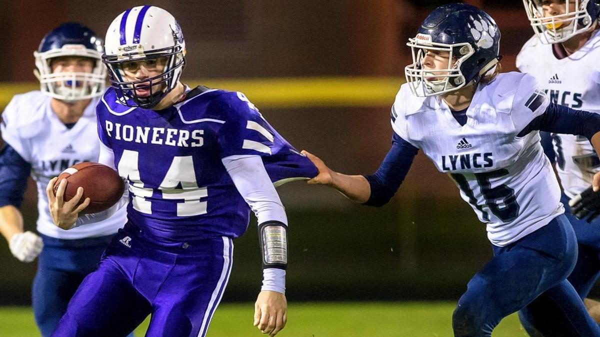 Lynden Christian’s Colby Flint, right, tries to stop Nooksack Valley’s Colton Kautz at the line of scrimmage during the second quarter on Friday, Oct. 28, at Nooksack Valley High School.