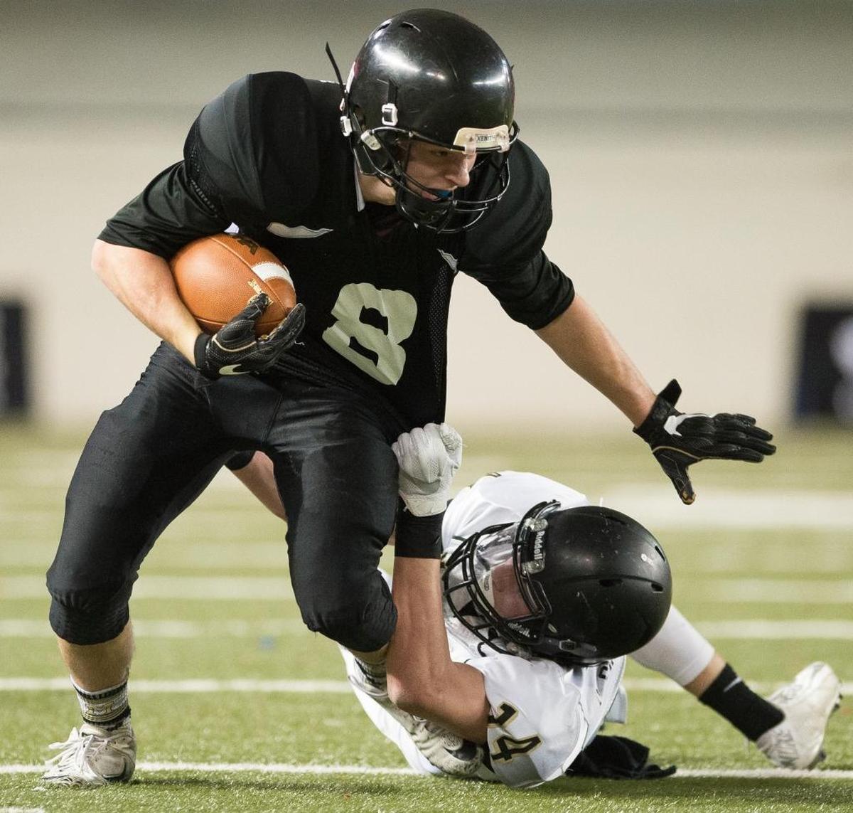 Meridian’s Bryce VandenHaak is dragged down by Royal’s Corbin Christensen in the 1A state championship game Saturday, Nov. 2, at the Tacoma Dome.