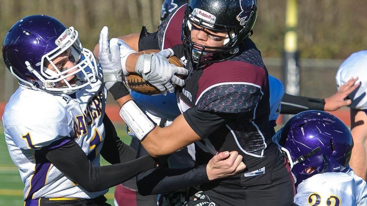 Lummi’s Trazil Lane, center, battles for yardage against Quilcene during the Class 1B State Quarterfinals on Saturday, Nov. 21. The Blackhawks will face Neah Bay in the state semifinals on Friday, Nov. 27, at the Tacoma Dome.