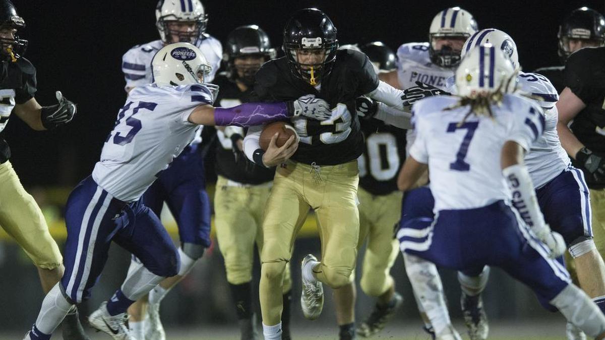 Meridian quarterback Simon Burkett looks for running room against Nooksack Valley during Friday’s game in Laurel.