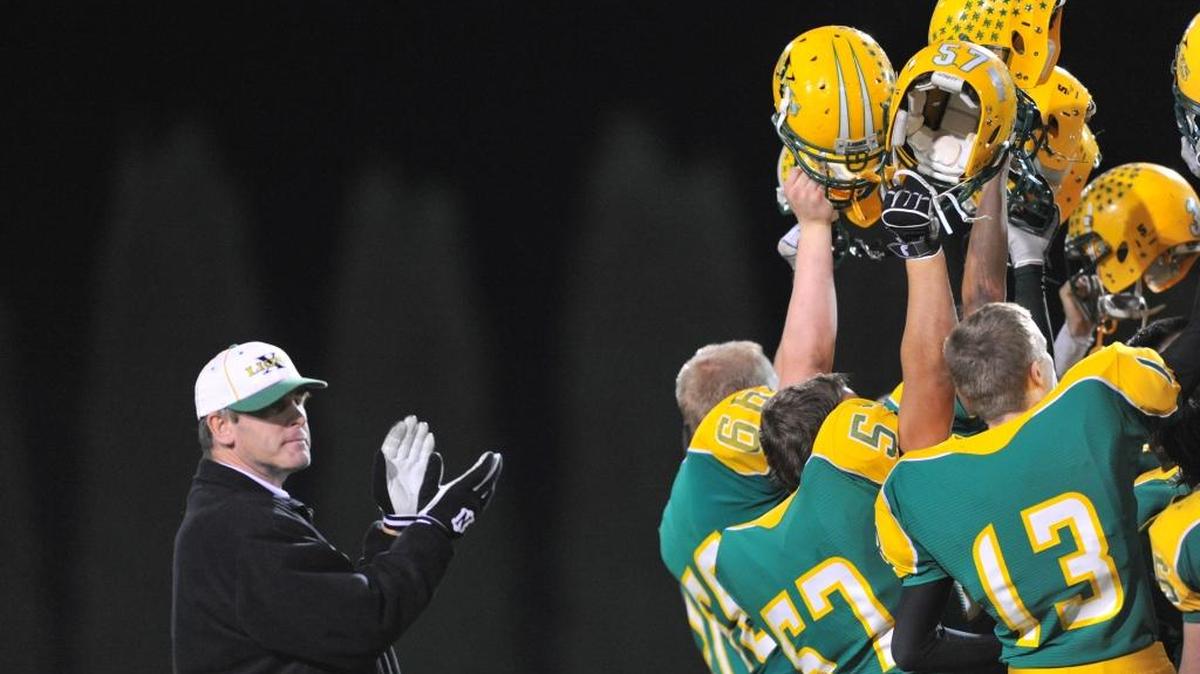 Lynden head coach Curt Kramme claps as his team celebrates a victory over Burlington-Edison in 2010. Every team in the Northwest Conference are expected to pay tribute to former Lynden coach Curt Kramme by wearing helmet stickers this season.