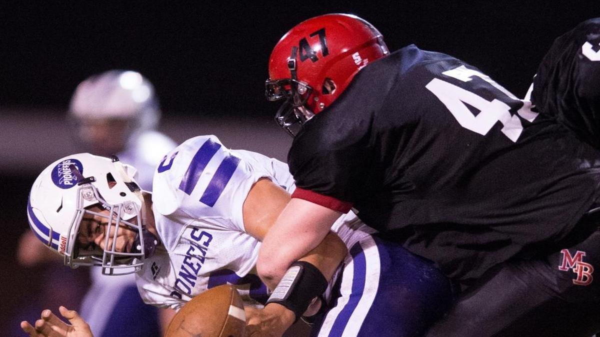 Mount Baker’s T.J. Bass sacks Nooksack Valley’s Casey Bauman while forcing a fumble in the process on Friday, Sept. 23, at Mount Baker High School in Deming. Mount Baker defeated Nooksack Valley 44-36