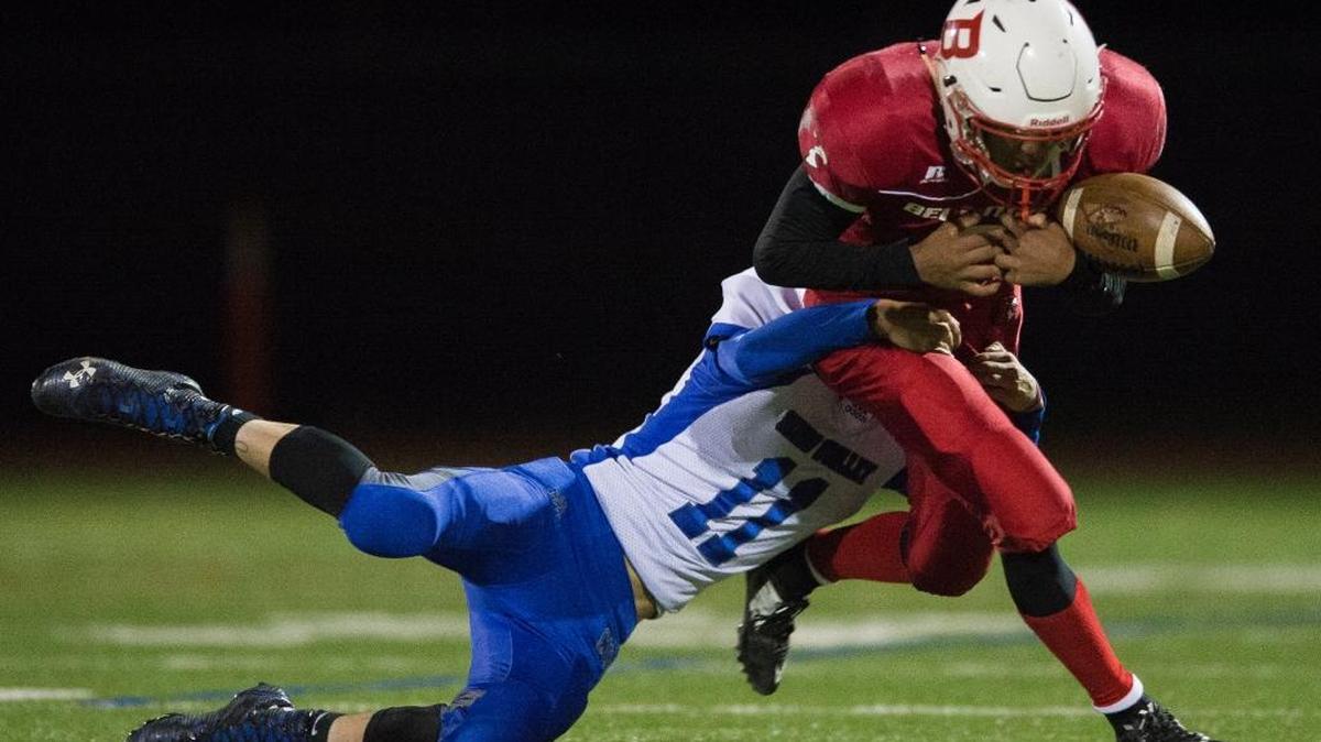 Sedro-Woolley’s Chance Whipple, left, forces a fumble by Bellingham's Spencer Lee Saturday, Oct. 14, at Civic Stadium in Bellingham. Sedro-Woolley defeated Bellingham 59-20.