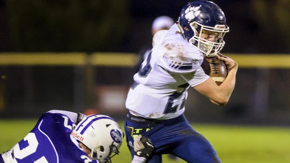 Lynden Christian’s Jordan Riddle tries to avoid Nooksack Valley’s Kyle Veldman Oct. 28 in Everson.