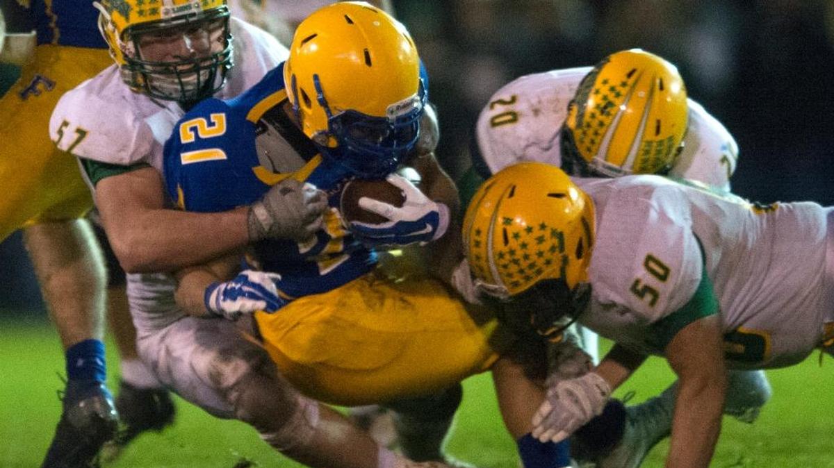 
Lynden’s Brody Weinheimer (57), Conner Shine (20) and Jensen Mayberry (50) combined for a tackle on Ferndale running back Cole Semu (21) during the Lions’ 34-7 win over the Golden Eagles on Friday, Oct. 16, at Ferndale High School.
