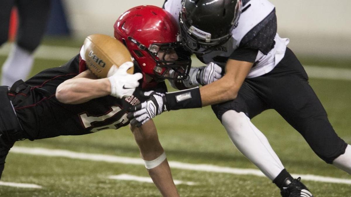 Lumm’'s Raven Borsey puts a devastating hit on Neah Bay’s Cole Svec during a failed two-point conversion attempt by the Red Devils during the Class 1B State Semifinal game Nov. 27 at the Tacoma Dome.