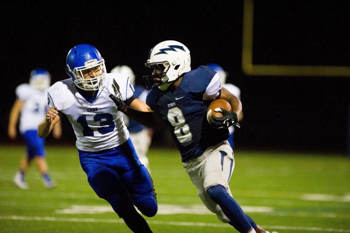 Scqualicum’s Damek Mitchell stiff arms Sedro-Wooley’s Billy Hornbeck after a reception on Sept. 25.