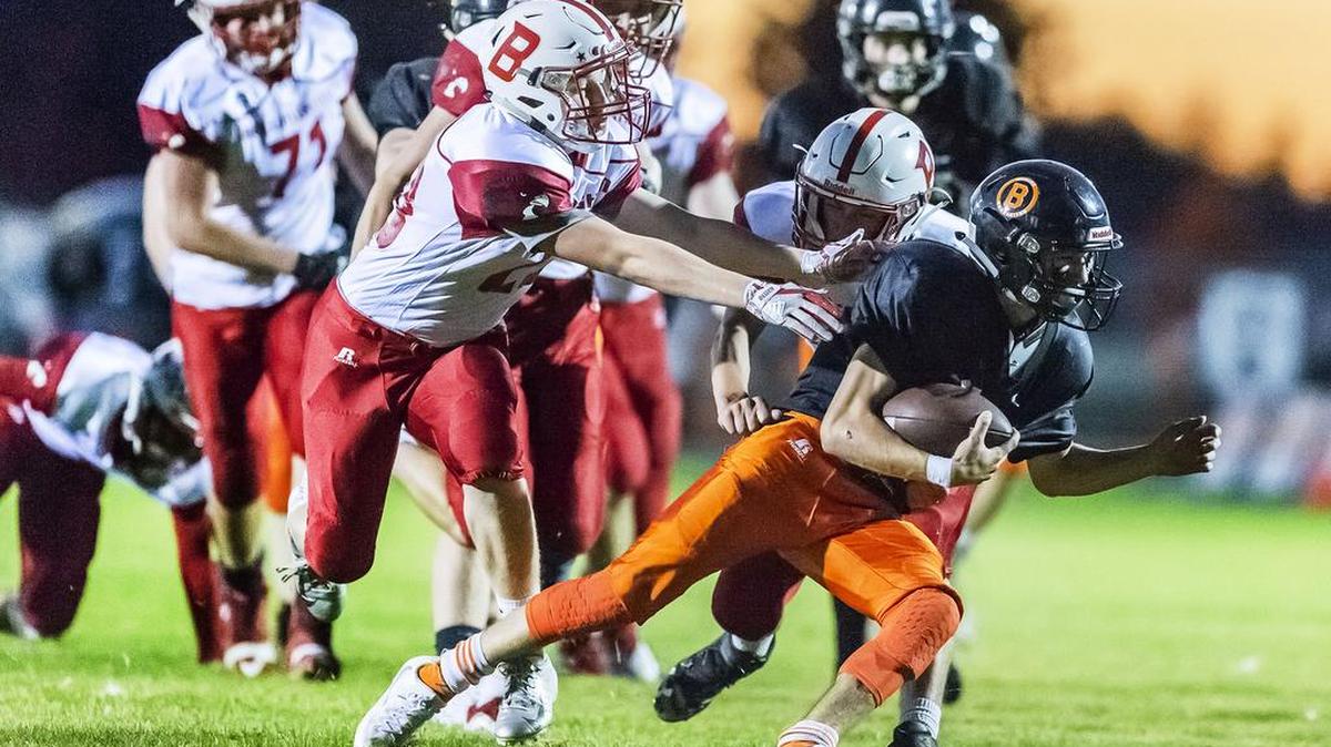 Bellingham defensive men Braeden Wood (28), left, and Spencer Lee (2) grab Blaine running back Alex Mercado (2) from behind preventing extra yardage during the first quarter on Friday evening Sept. 28, 2018, at Blaine High School in Blaine, Wash. Bellingham defeated Blaine 14 to 13.