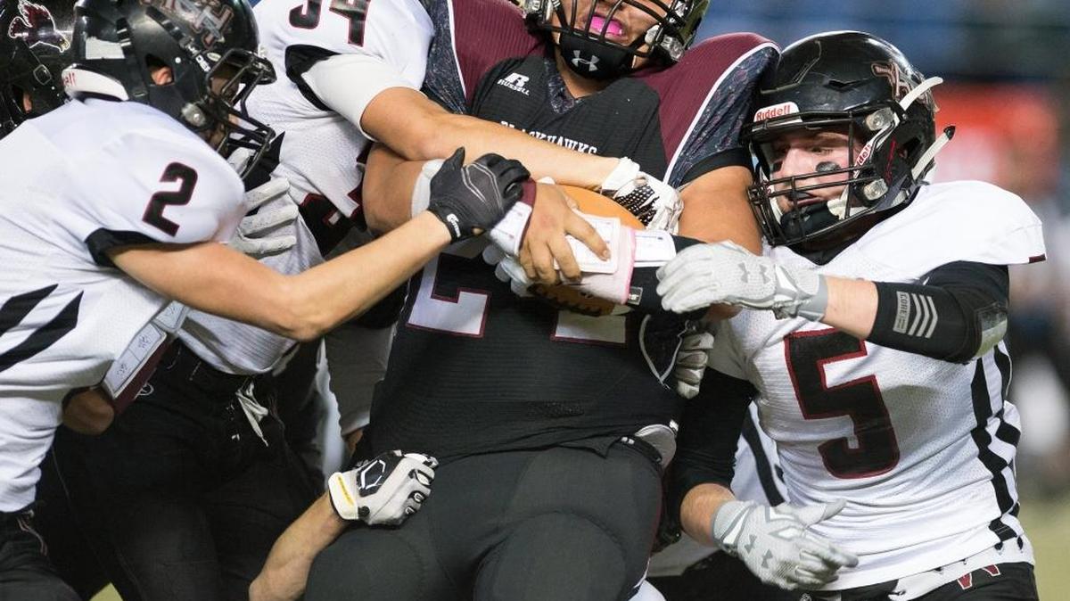 Lummi’s Hank Hoskins drags at least four Almira-Coulee-Hartline defenders with him as he runs for a first down during the Class 1B State Championship on Friday, Dec. 4, at the Tacoma Dome.