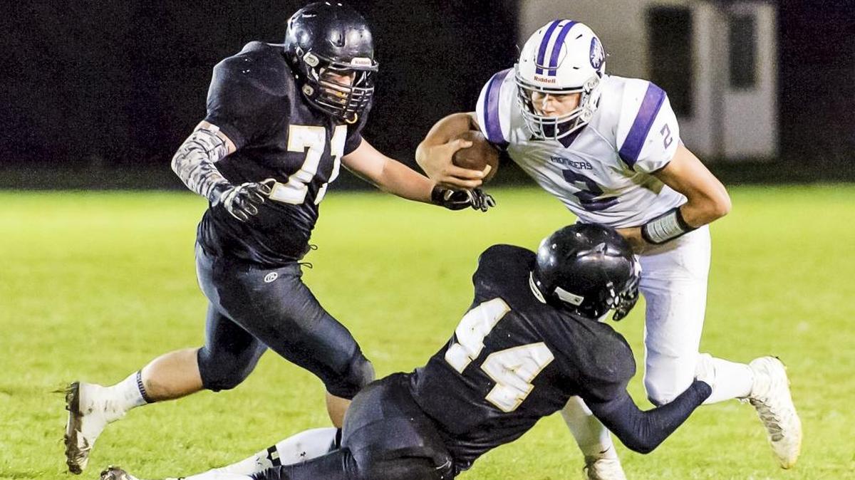 Meridian's Jackson Day, left, moves in as team mate Koby Smith sacks Nooksack Valley quarterback Casey Bauman on Oct. 30. Meridian will face Hoquiam on Saturday, Nov. 14, in the first round of the Class 1A State Playoffs.