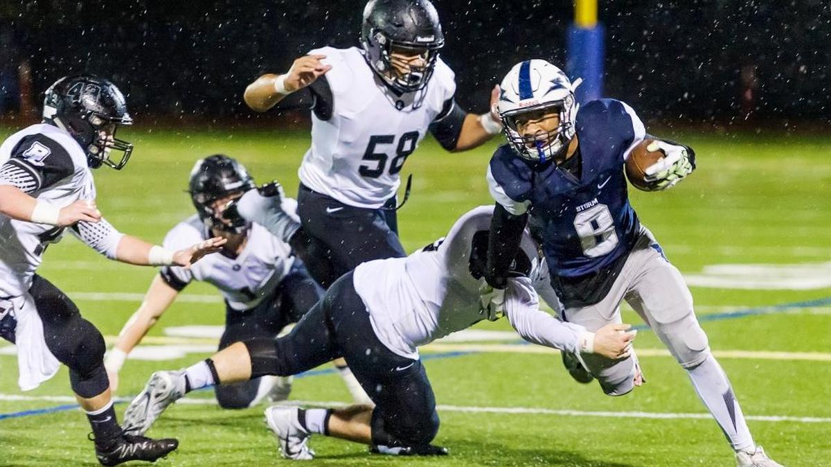 Squalicum’s Damek Mitchell (8) is wrapped up by Bonney Lake’s Riley Teed (19) after a 10-yard gain during the second half of the Class 3A state playoff game Friday at Civic Stadium.