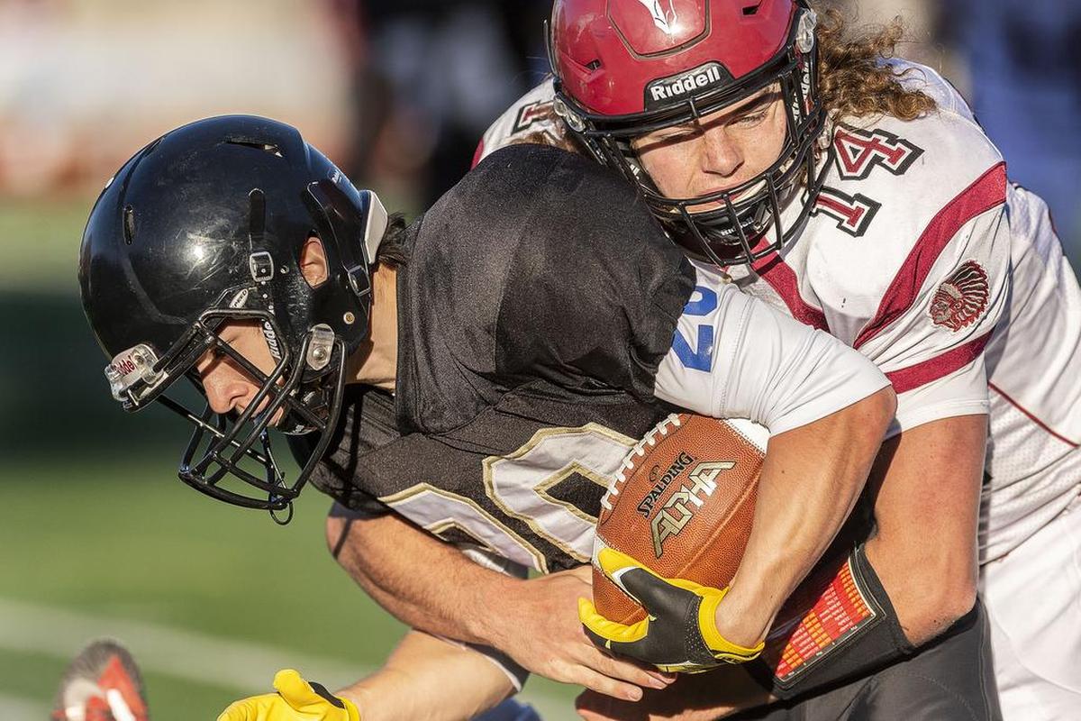 Colville defensive back John Knight (14) takes down Meridian wide receiver Josh Neeter (20) behind the line of scrimmage for a loss during the third quarter of the 1A state playoffs on Saturday at Civic Field in Bellingham. Colville defeated Meridian 42-22.
