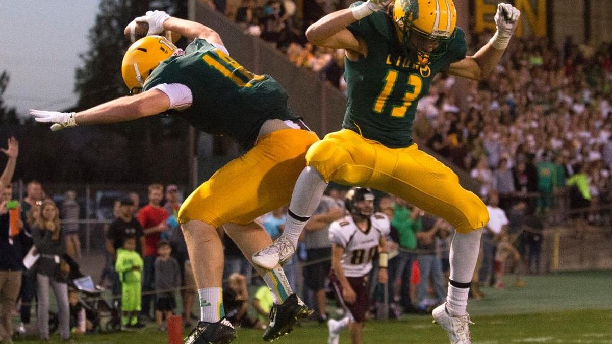 
Lynden’s Ben Colwell, left, celebrates scoring a touchdown with teammate Rylan Severson on Friday, Sept. 11, at Lynden High School in Lynden.
