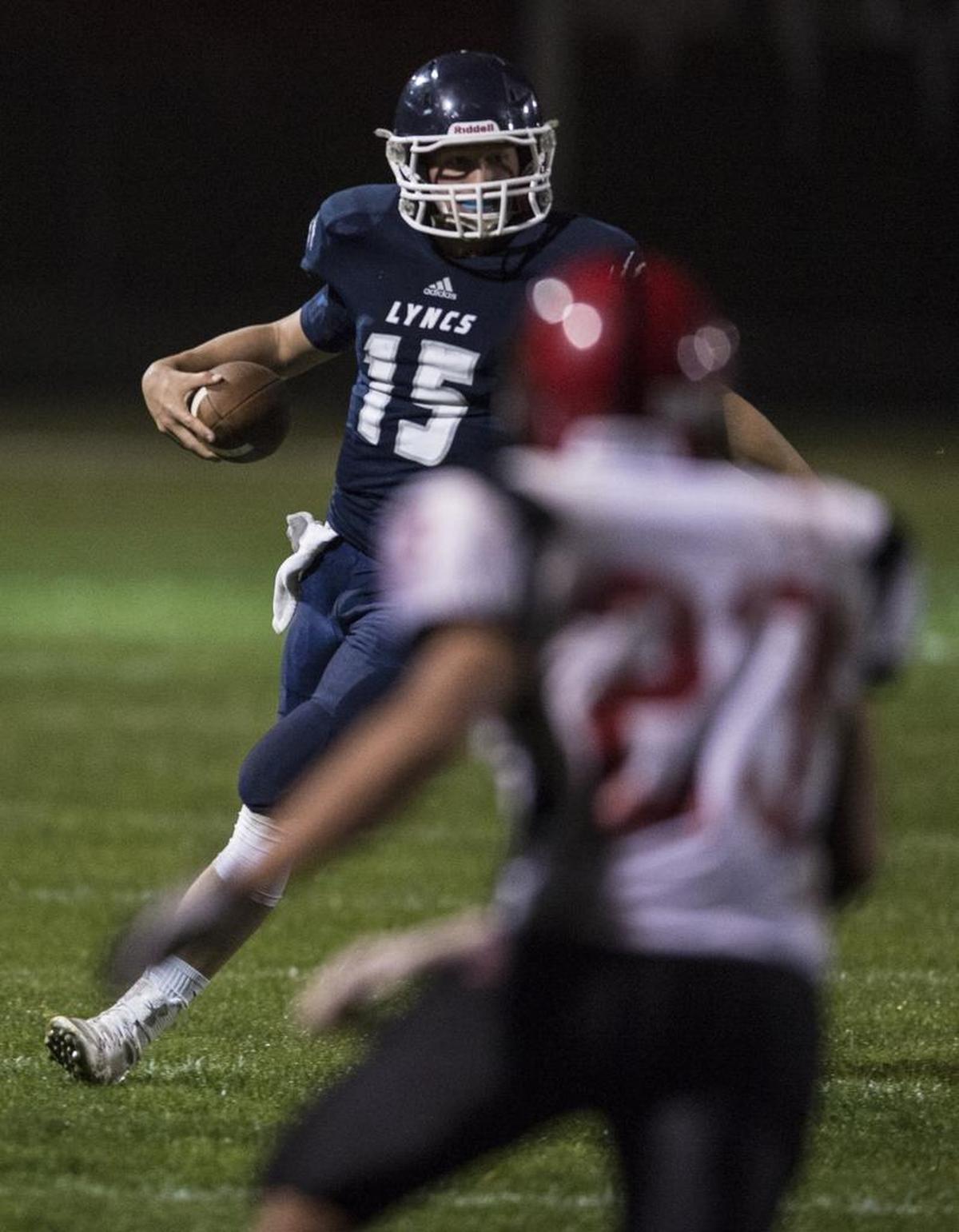 Lynden Christian’s Lucas Roetcisoender looks downfield in a game against Mount Baker during the 2014 season.
