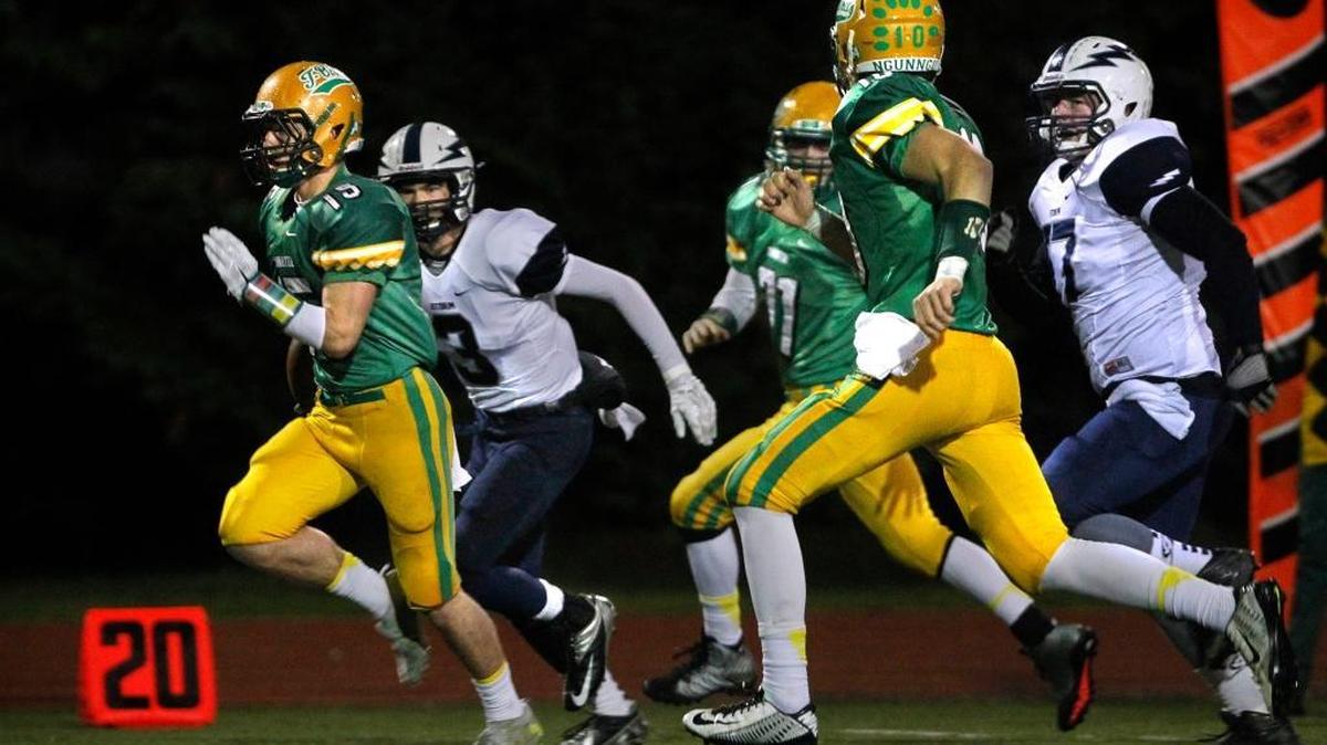 Tumwater wingback Easton Trakel breaks away from Squalicum defenders Coleman Schwab (3) and Jack Wendling for a 33-yard touchdown run during during the Class 2A state quarterfinals in 2014. The Thunderbirds and Storm could meet again in the state quarterfinals this year.