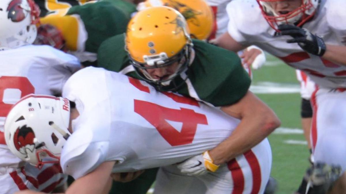 
Sehome’s Anton Arena wraps up Bellingh’s Dakota Johanson on Friday, Sept. 11, at Civic Stadium
