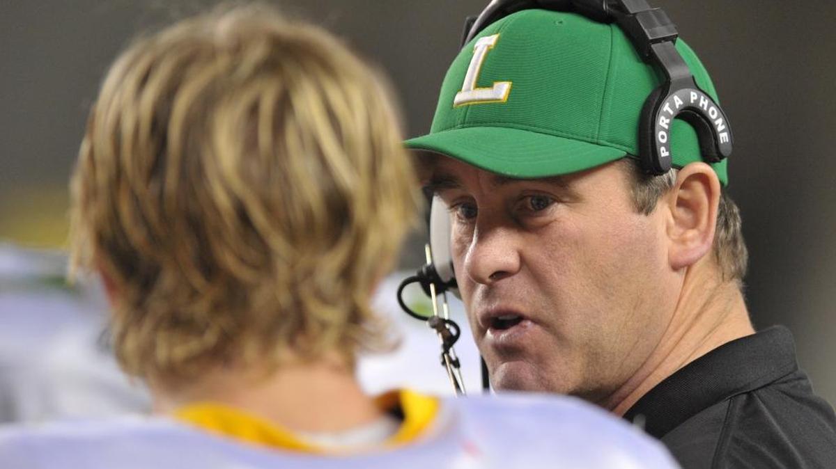 Lynden head coach Curt Kramme, right, talks with quarterback Josh Kraght during a timeout during the 2011 Class 2A State Championship Game at the Tacoma Dome.