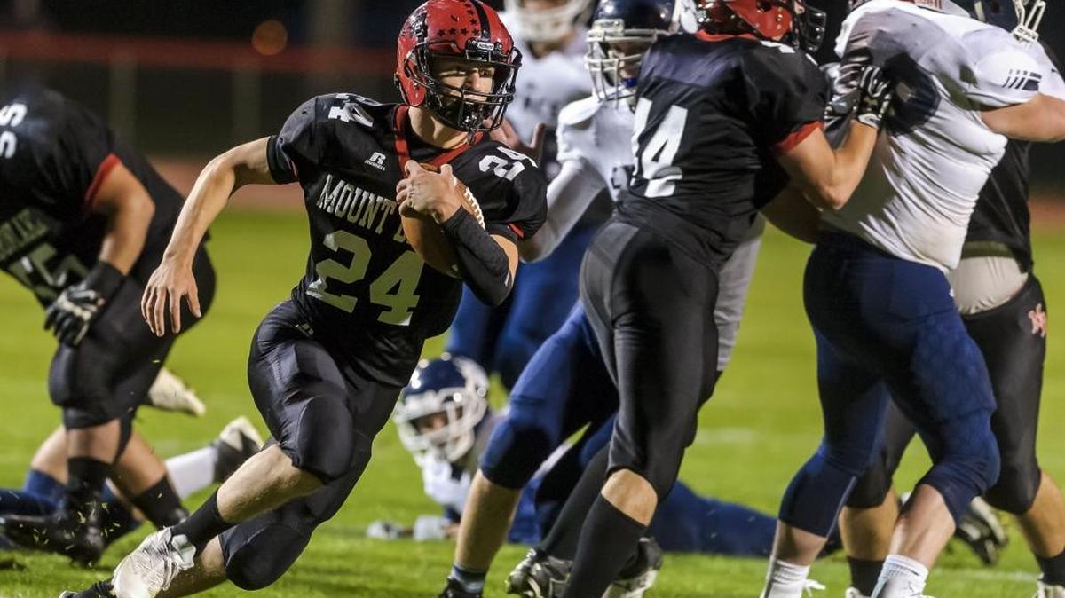 Mount Baker running back Carson Engholm sweeps past the Lynden Christian defensive line Sept. 29. The Mountaineers travel to face La Center in the first round of the Class 1A state playoffs Friday.