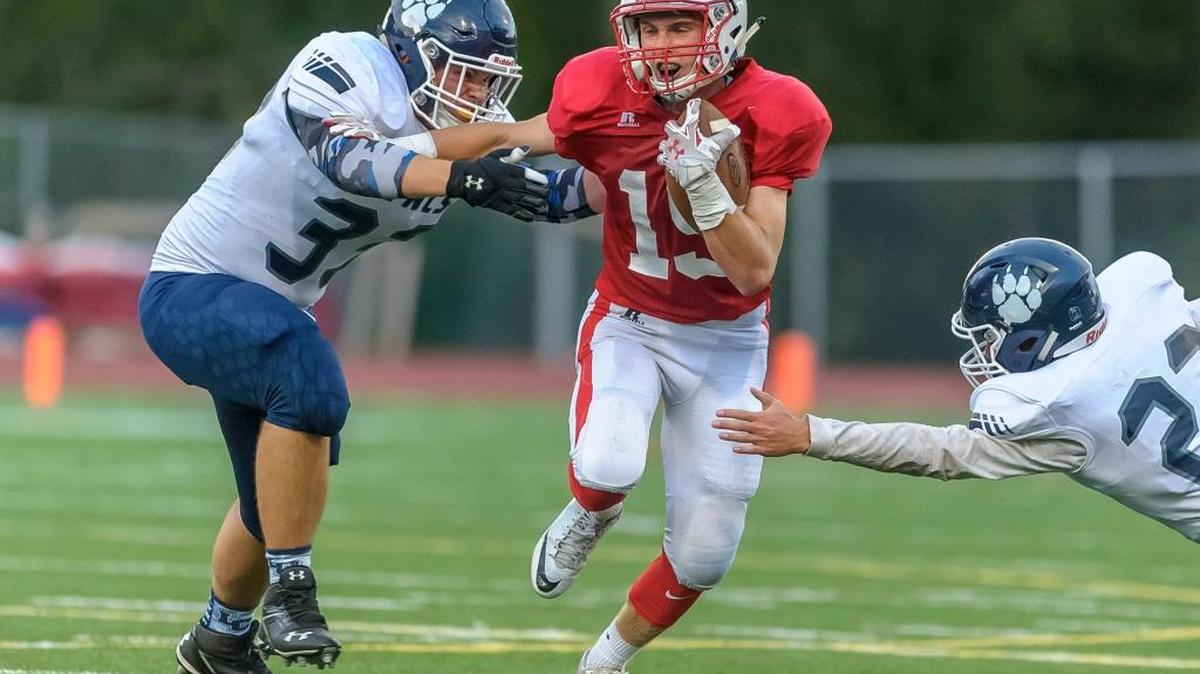 Bellingham’s Connor Wallace, center, tries to avoid Lynden Christian’s Huter TeVelde, left, and Jordan Riddle in a Sept. 2, 2016, game at Civic Stadium.