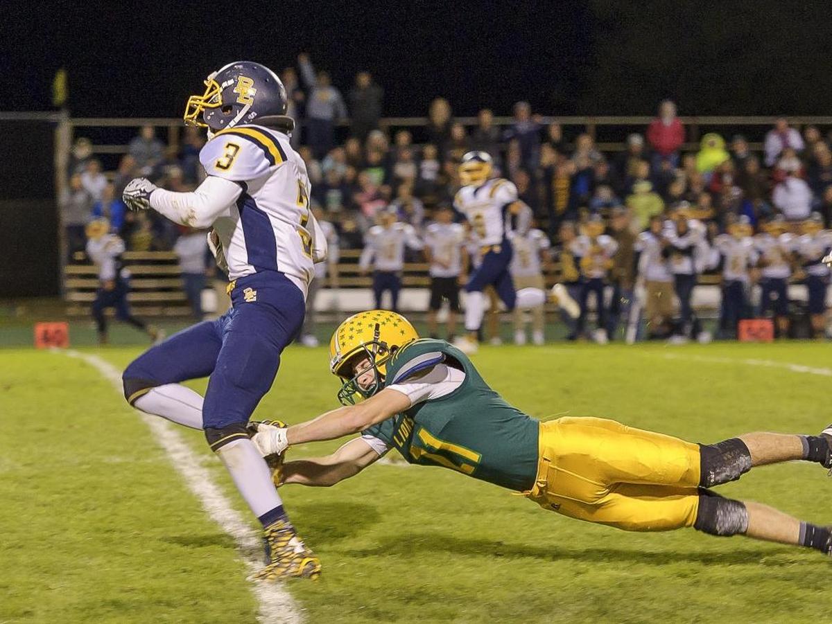 Lynden’s Drew Krause (21) attempts to tackle Burlington-Edison running back Taran Lambert (3) on Oct. 9.