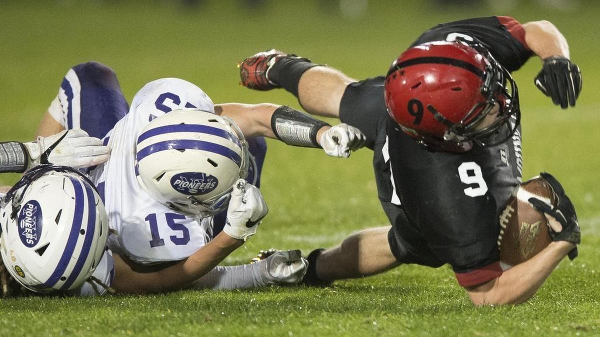 Mount Baker’s Carson Brandland, right, is brought down by Nooksack Valley’s Austin O’Bryan Oct. 13.