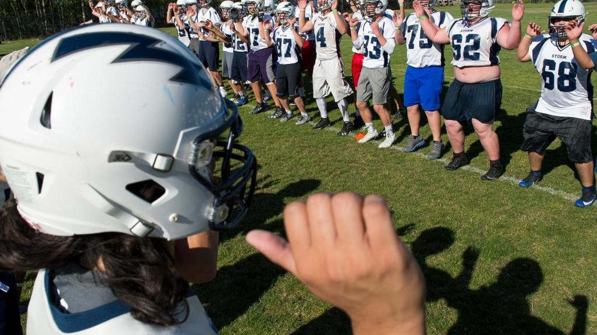 Squalicum football players warm up on the first day of football practice Wednesday at Squalicum High School in Bellingham.