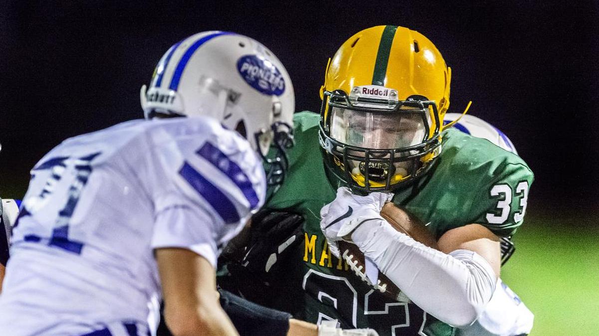 Sehome running back Dawson Smith (33) is stopped cold by a slew of Nooksack defenders during the second quarter of their season opener at Civic Field on Friday in Bellingham, Wash. Sehome won 14-13.