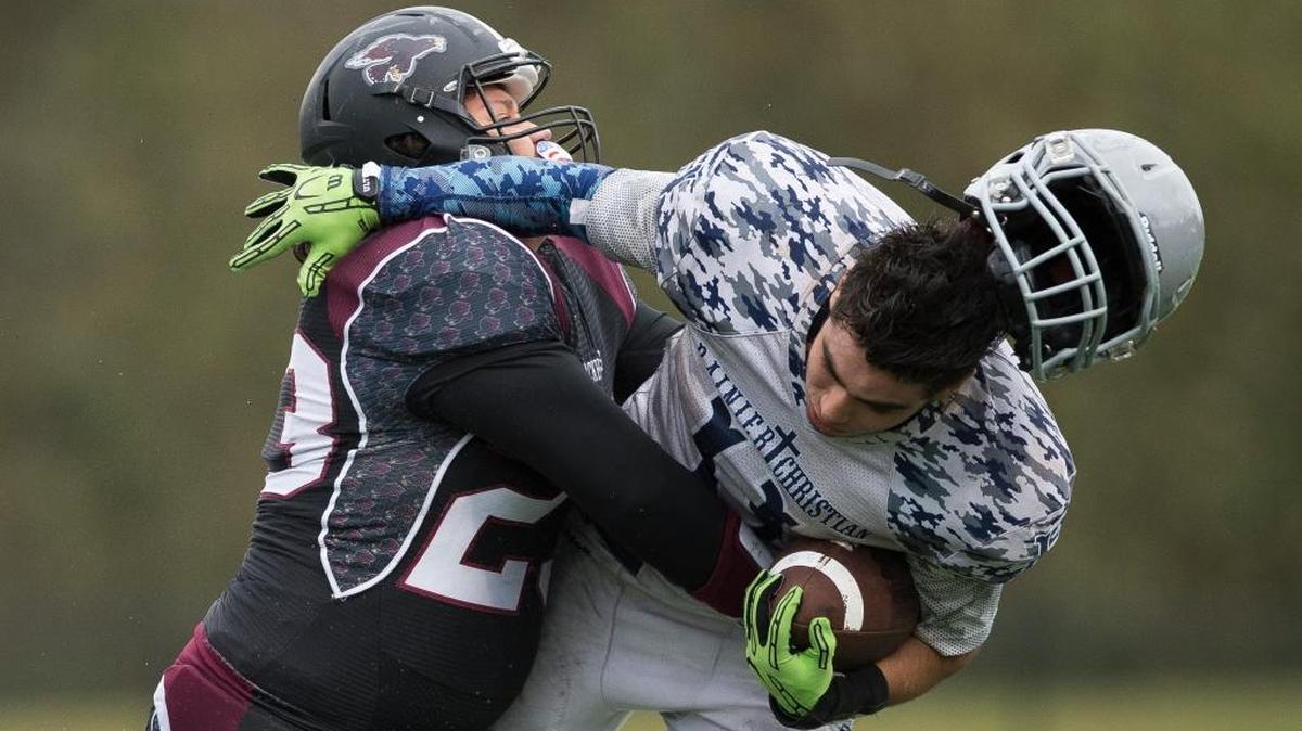 Lummi’s Stanford Hoskins, left, delivers a big hit to Rainier Christian’s Greg Gonzalez to cause a turnover on downs Saturday, Nov. 11, at Lummi Nation School. Lummi defeated Rainier Christian 58-16 to advance to Class 1B state playoffs.