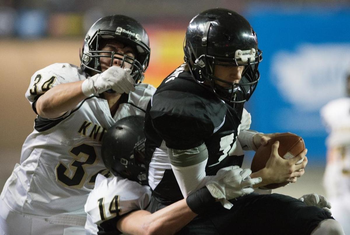 Meridian's Simon Burkett falls into the end zone with Royal defenders clinging to him for a touchdown in the 1A state championship game Saturday, Nov. 2, at the Tacoma Dome.
